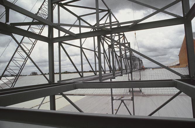 Working on steel frame construction outside building