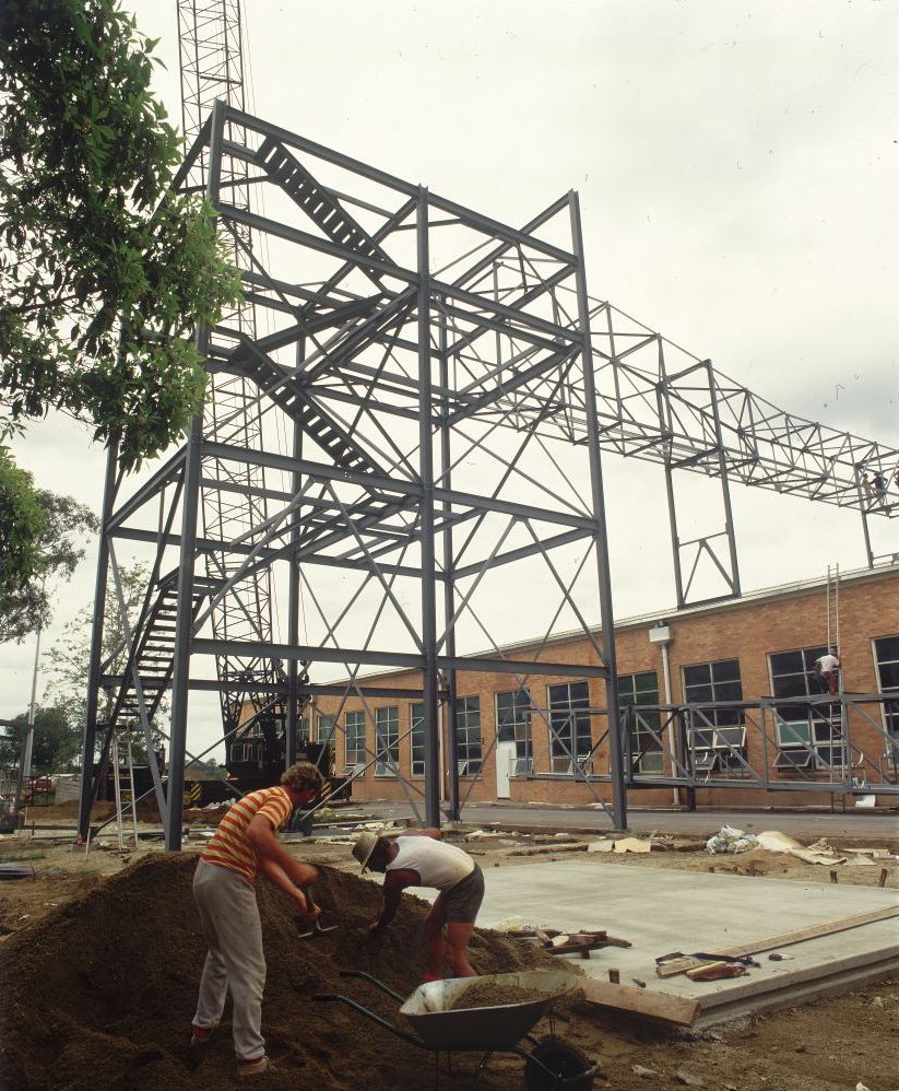 Working on steel frame construction outside building