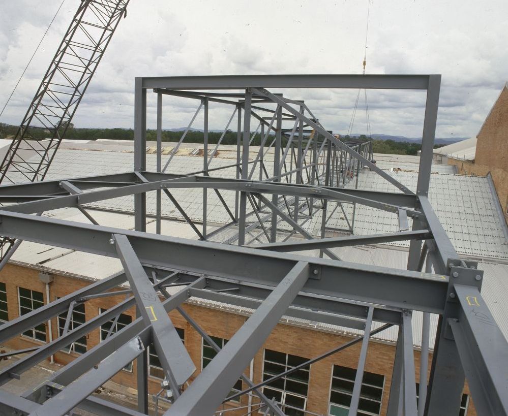 Working on steel frame construction outside building