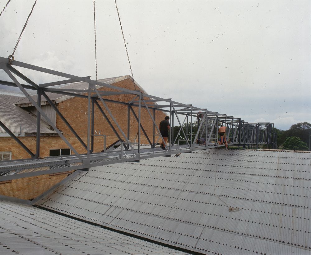 Working on steel frame construction outside building