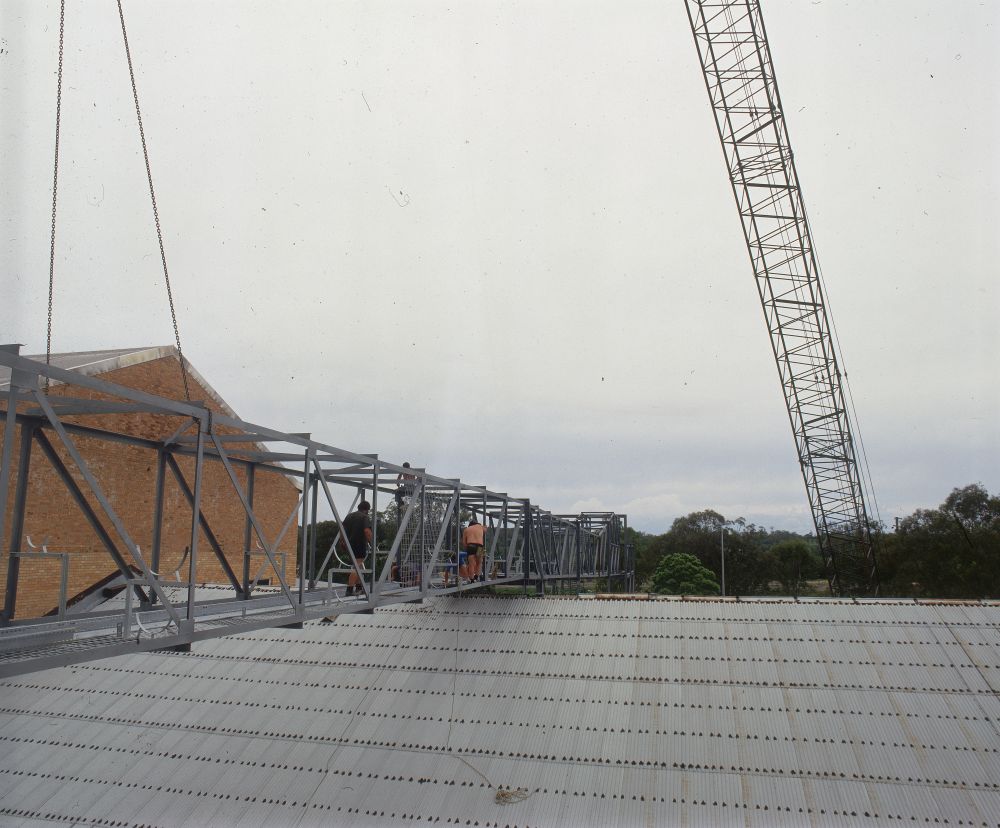 Working on steel frame construction outside building