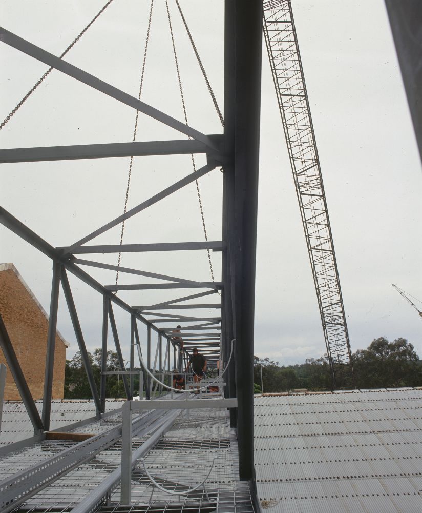 Working on steel frame construction outside building
