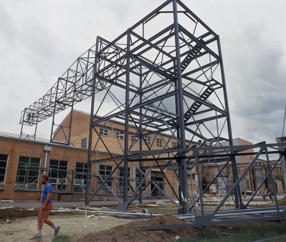 Working on steel frame construction outside building