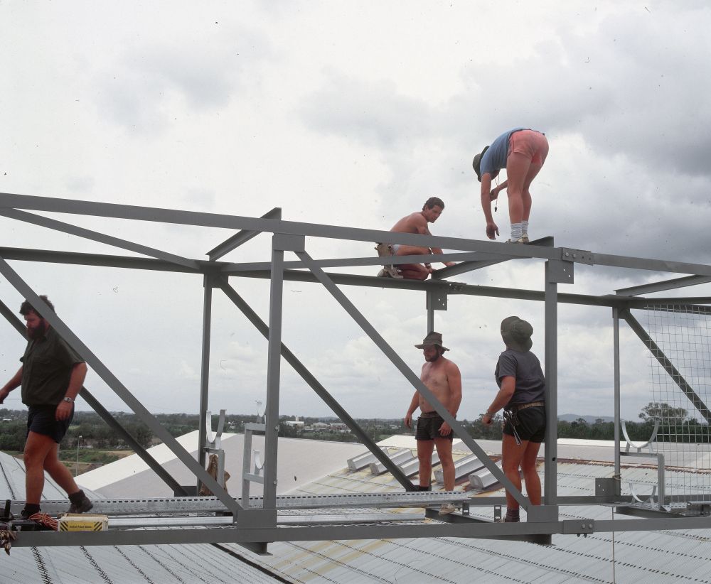 Working on steel frame construction outside building