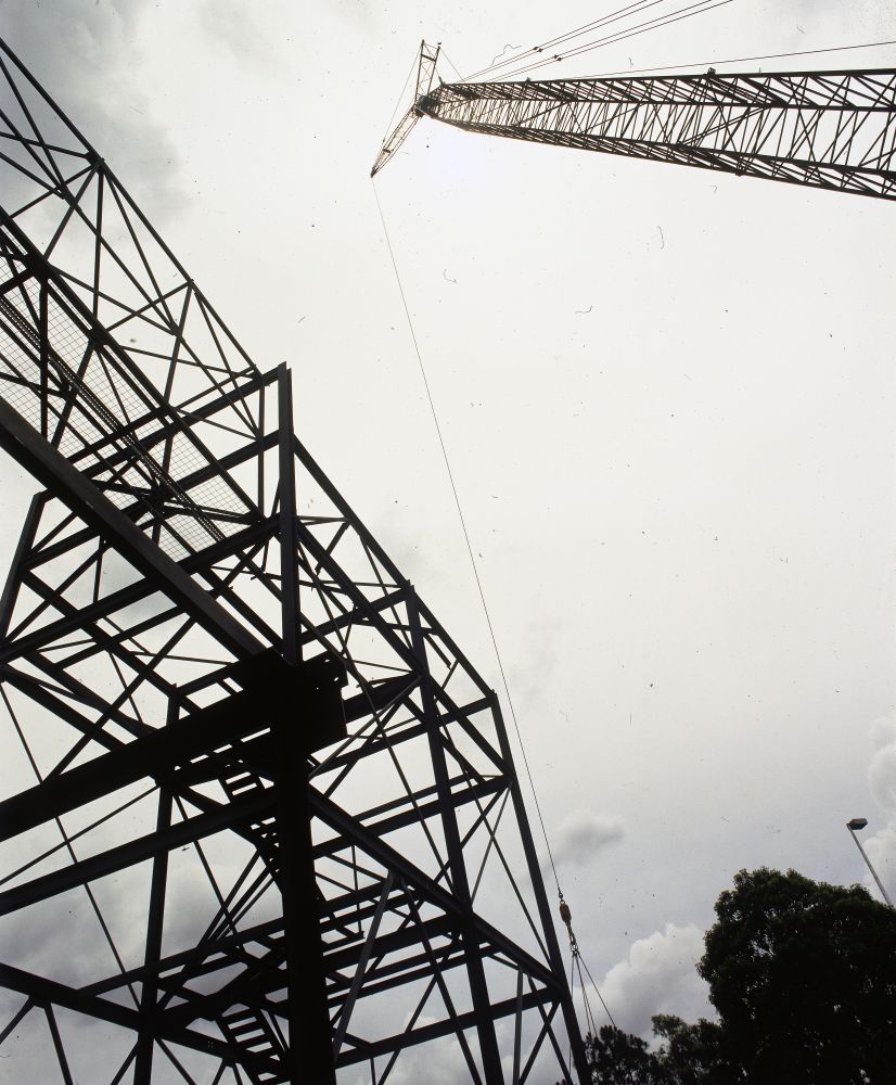 Working on steel frame construction outside building