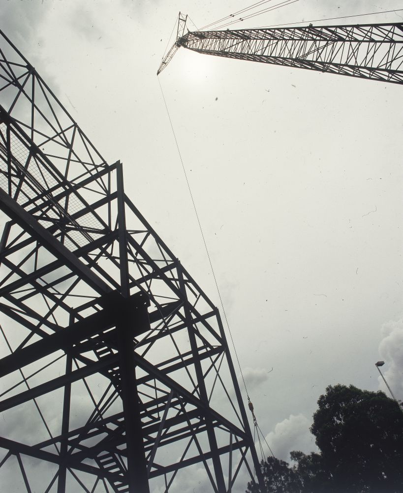 Working on steel frame construction outside building