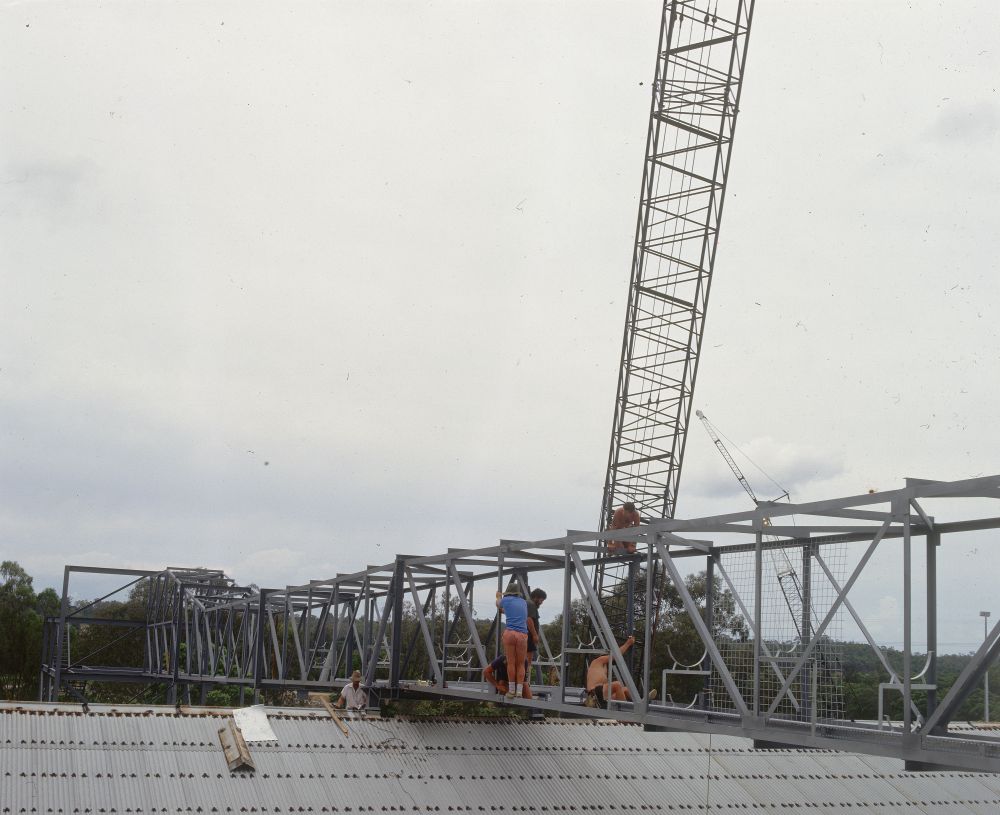 Working on steel frame construction outside building