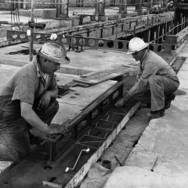 Bob Chambers and Harry Pollock working on the floor