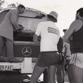 Demonstration to a group of men about an old truck