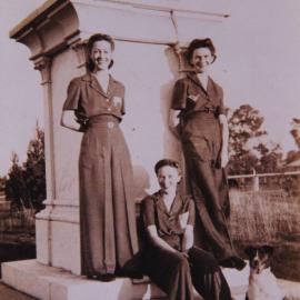 Three women and a dog at the second site of the Tom Petrie Memorial, Petrie, early 1940s.