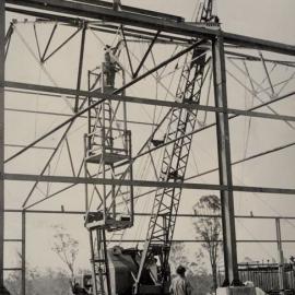 Building under construction - Crane lifting beams
