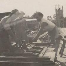 3 Men working on machinery for mill construction