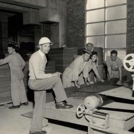 6 Male Workers Working on Machine