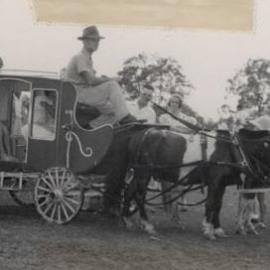 Children in a miniature stage coach