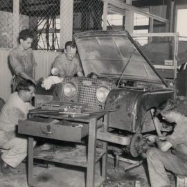 4 Men working on the Land Rover
