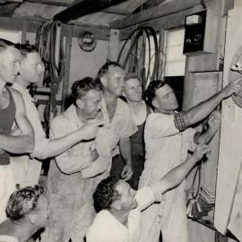 8 Male Workers playing darts