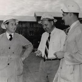 3 Men in front of Mill Buildings