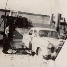 Car coming off of Barge in to sand